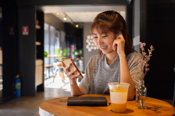 Women use smart phone in coffee cafe