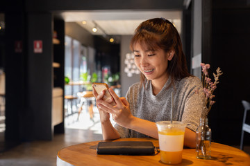 Women use smart phone in coffee cafe