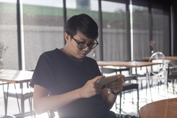 young man use smart phone in coffee cafe
