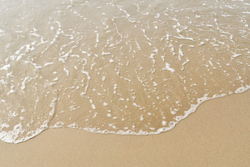Waves washing along sand on a beach