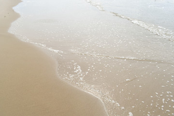 Waves washing along sand on a beach