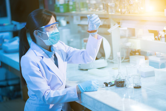 Young Female Scientist Or Researcher In Medical Lab With Test Tube Centrifuge And Flask