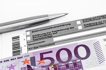 Steuerformular mit Kugelschreiber und Geldschein