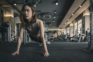 Naklejka na ściany i meble Woman exercise in the fitness gym.