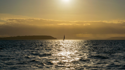Sailboat, sailing towards sunset