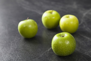 green apples on black background