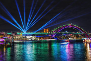 Colorful projection lights above city in night