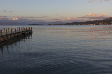 Fototapeta na wymiar wooden pier in the sea against the beautiful sunset sky, a place for relaxation and meditation
