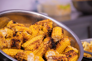 Grilled corn grilled on fire with red pepper