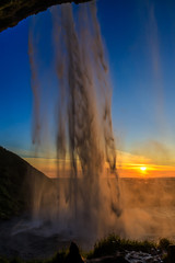 Behind of waterfall with sunset