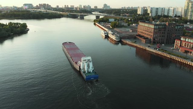 Top view of empty barge without cargo float along the river in summer sunny day