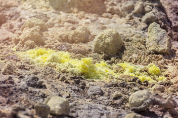 abstract background image texture of the breath of the volcano, white limestone rock with crystals of yellow sulphur