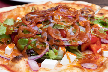 Photo of a pizza close-up, seen ingredients.