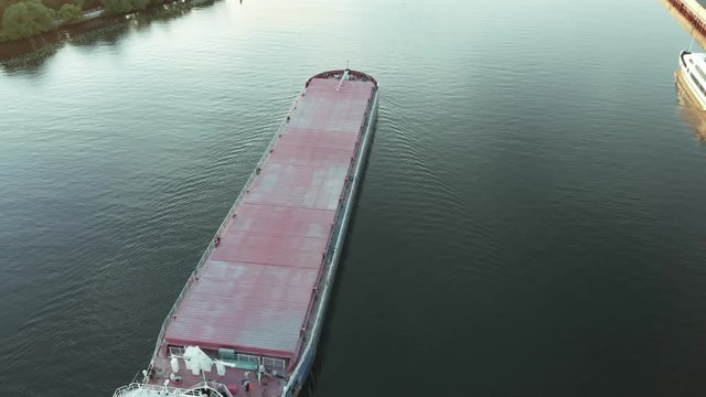 Top view of empty barge without cargo float along the river in summer sunny day