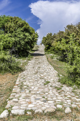 Stone road goes to the top of the hill