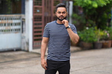 Young bearded Indian man in the streets outdoors