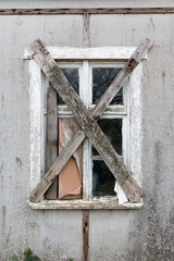 View of an old window nailed down with planks