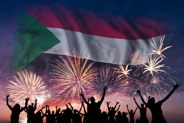 People are looking on fireworks and flag of Sudan