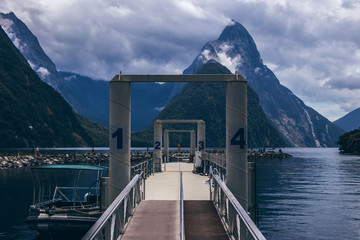 Boat and pier on lake near mountains
