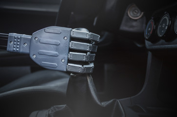 Robot hand on car gearstick. Robot pilot is driving a car. Automatic driver concept.