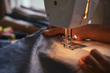 Fashion designer working in sewing machine at night