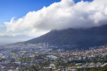 View of Cape Town on Table mountain and huge white cloud on blue sky background, South Africa