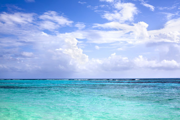 Fototapeta na wymiar Blue sea, horizon line, blue sky with clouds background