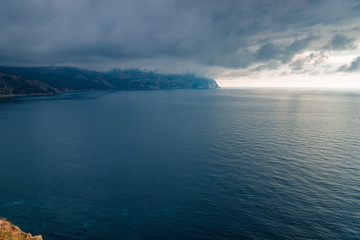 Nature before the storm - black clouds, dramatic sky above the calm sea