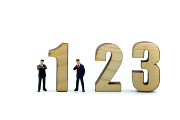 Miniature people : Businessman and team with wooden number of 1,2,3 , to be the first,business competition concept.