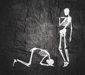 Fototapeta na wymiar Concept illustration of a obedience. Man prostrated under female foot. Silhouettes of two skeletons