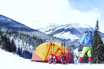 Snowshoe walker running in powder snow with beautiful sunrise light. Outdoor winter activity and...