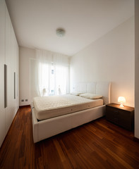 Fototapeta na wymiar Bedroom with large wardrobe and bright window
