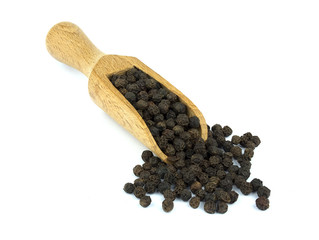 Black pepper on wooden scoop isolated on white background