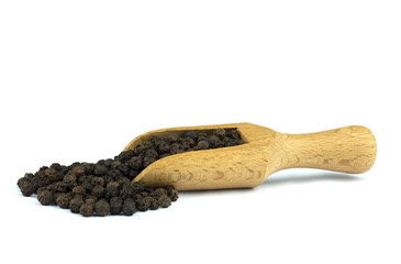 Black pepper on wooden scoop isolated on white background