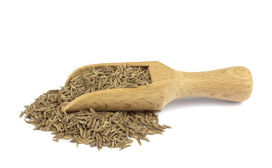 Cumin seed on wooden scoop isolated on white background