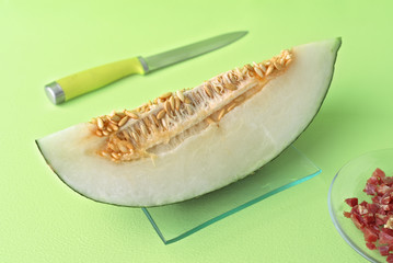 melon cut on green wooden board