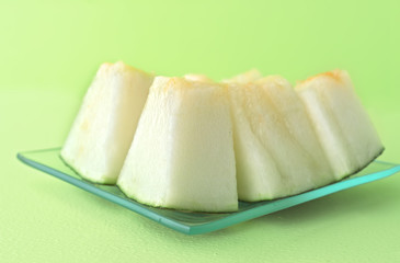melon cut on green wooden board