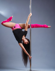Pole dance.Sexy girl on the pylon. The combination of dance with gymnastic exercises on the pylon