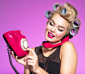 Young girl dials a phone number on an old phone