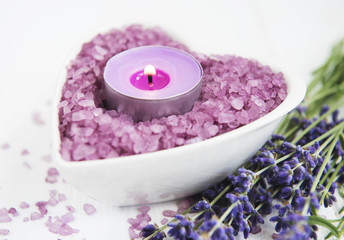 Heart-shaped bowl with sea salt, soap and fresh lavender flowers