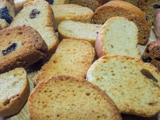 Freshly baked flour products fragrant and tasty croutons on a dark background with vanilla and raisins