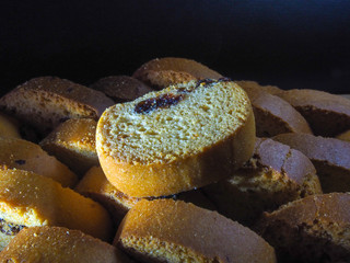 Freshly baked flour products fragrant and tasty croutons on a dark background with vanilla and raisins