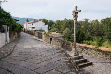 Fototapeta na wymiar Stone Cross and street in Allariz, province of Ourense. Galicia. Spain. 