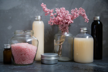 Natural spa cosmetics on a dark blue beton concrete background. Beauty blogger, minimalism concept, copy space