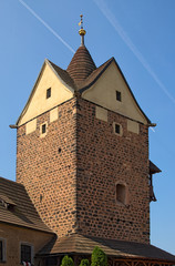 Square stone tower in the ancient Loket Castle under the blue sky at summer. Bohemia, Sokolov,...