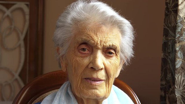 Portrait of caucasian 80 year old woman looking straight at camera