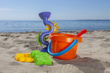 kids beach toys on sand in sunny day