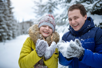 Fototapeta premium Happy young couple play in snow winter forest
