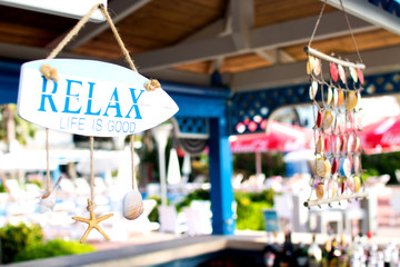 bar on the beach decorated with seashells and inscription "relax" in a hotel on the territory of Albania, the Adriatic coast