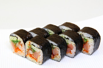 Roll with caviar of salmon. Sushi with caviar of flying fish. Japanese food on a beautiful dish.
